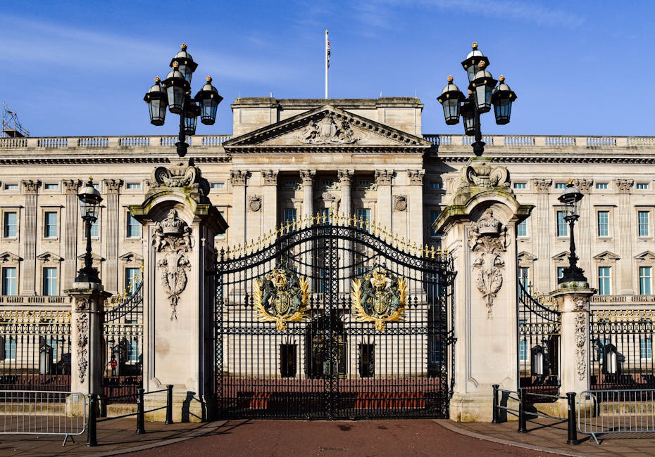 Photograph of a grand historic building constructed from light-colored stone with ornate architectural details. The facade features tall, evenly spaced rectangular windows with decorative moldings, an